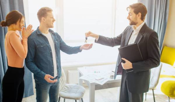 Home buyers getting house key from the home builder