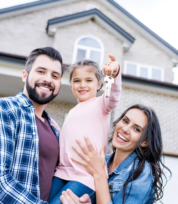 young family with keys moving into new house